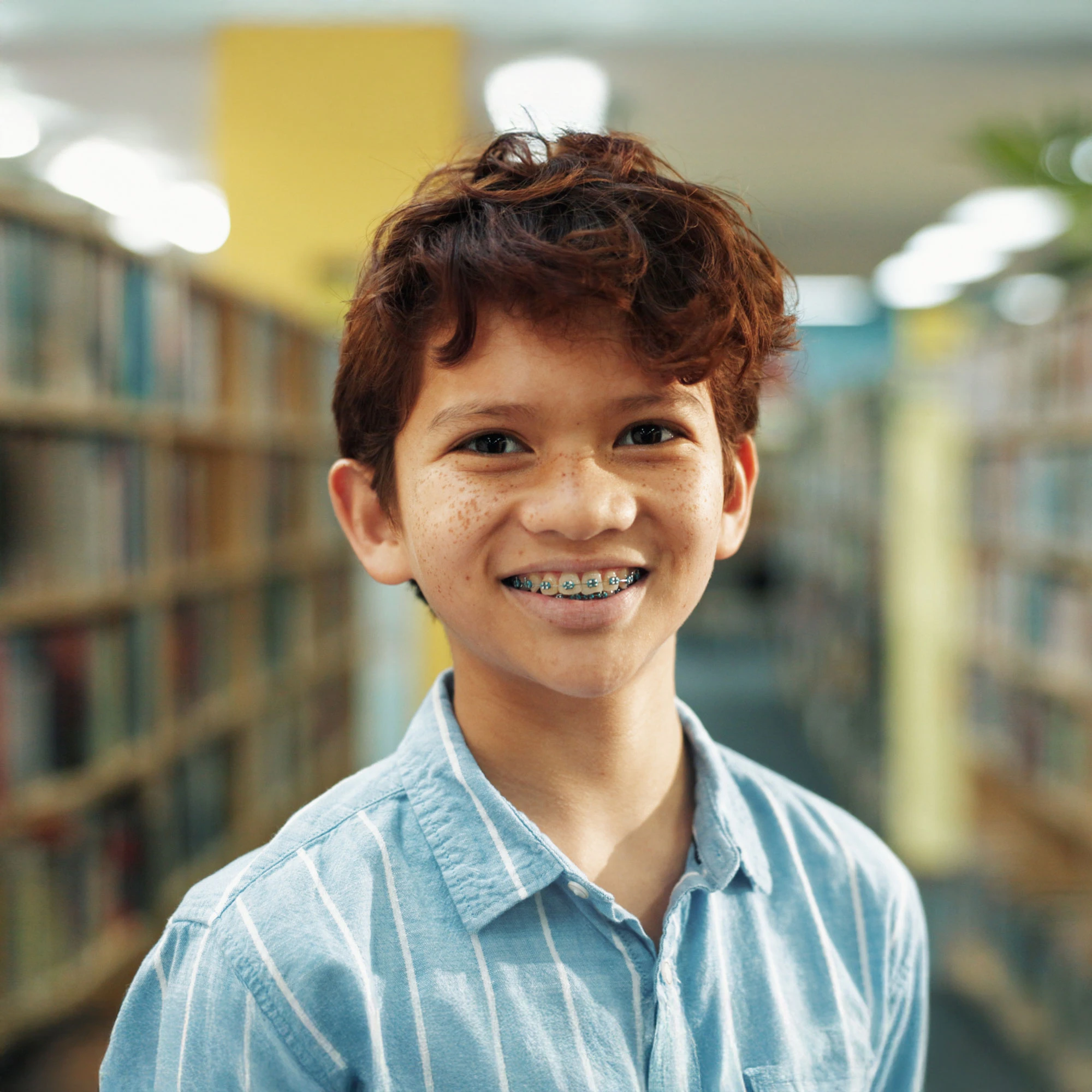 young boy with braces smiling