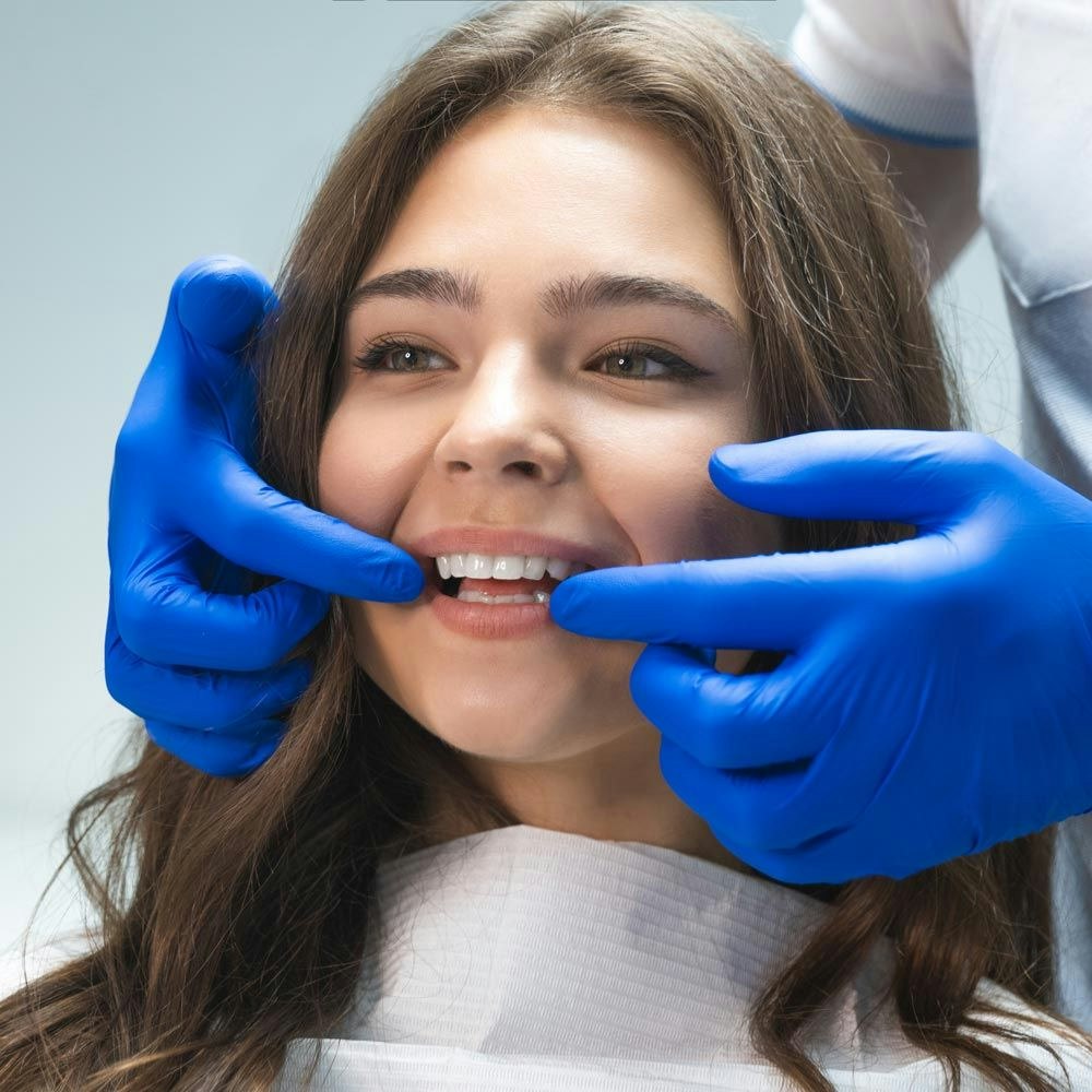 Dentist examining woman's smile