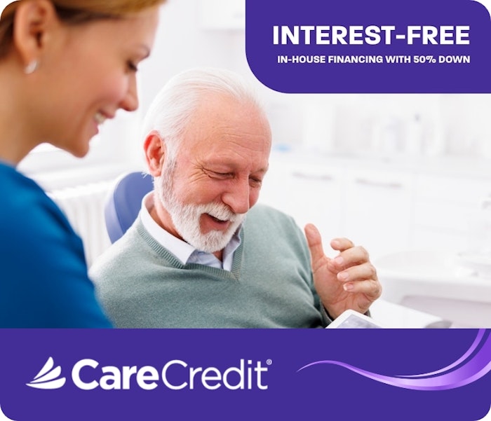 Senior man smiling during dental consultation with CareCredit logo and financing offer displayed