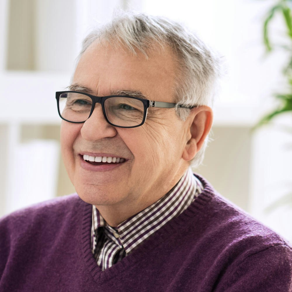 Mature smiling man shaking hands with doctor