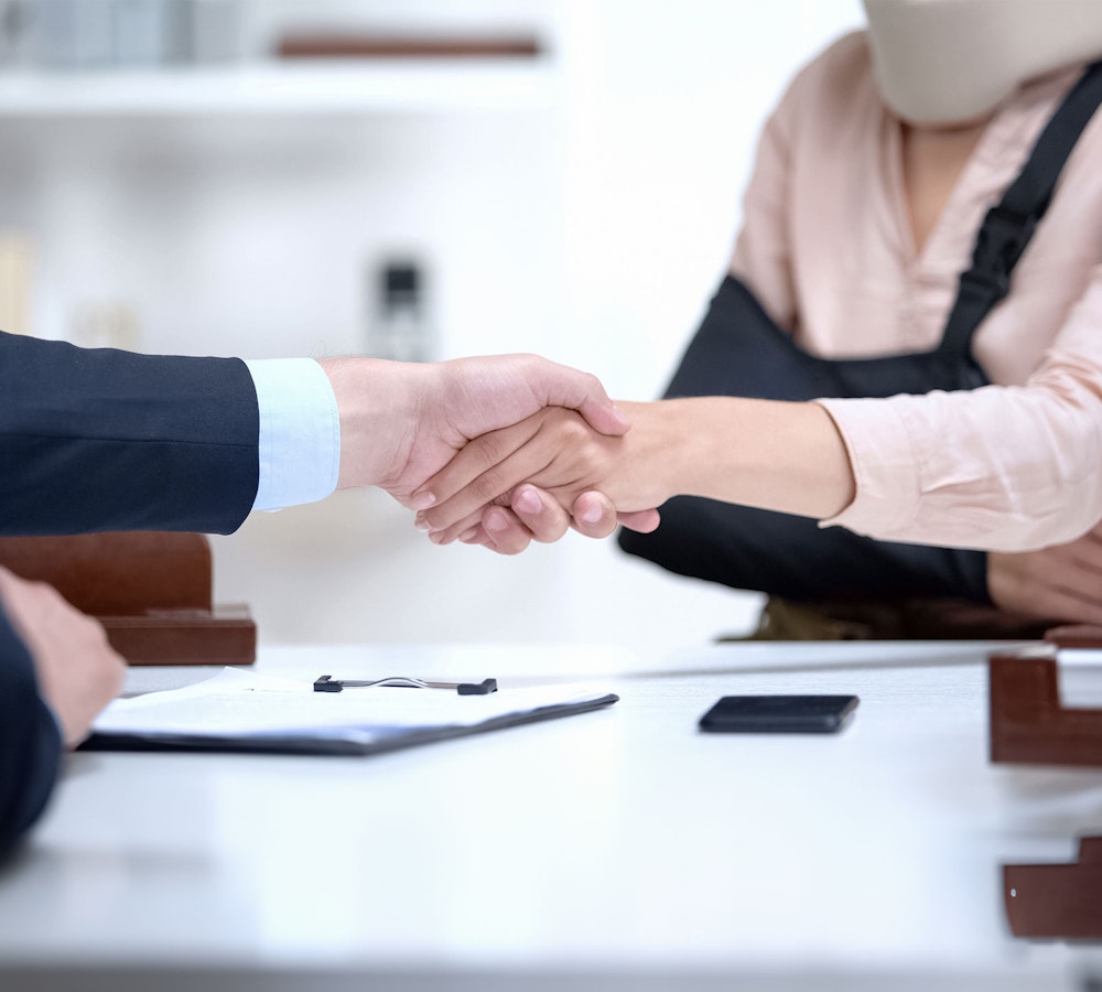 Lawyer shaking hands with an injured client