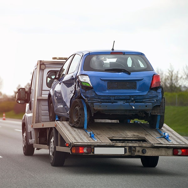 Damaged car being towed