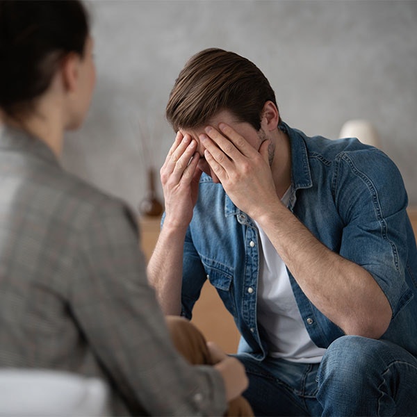 Man showing emotion while speaking to his therapist