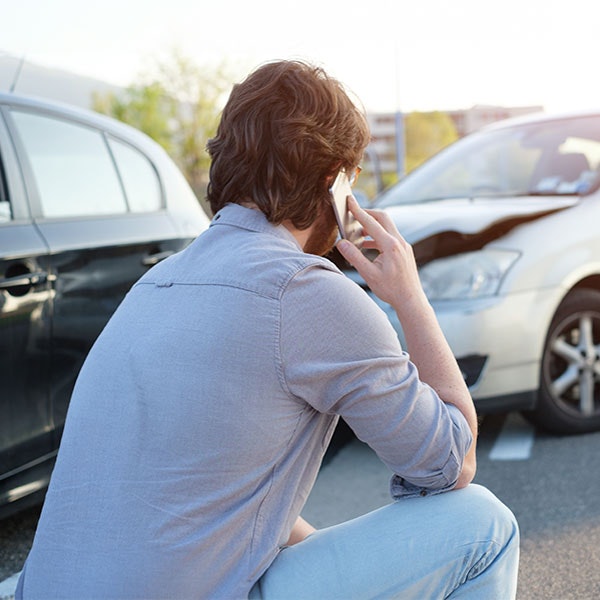 Man on the phone after car wreck