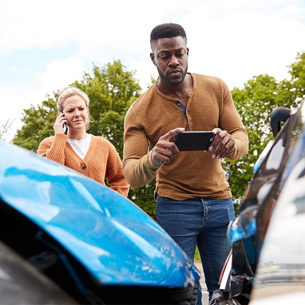 Man photographing cars after wreck