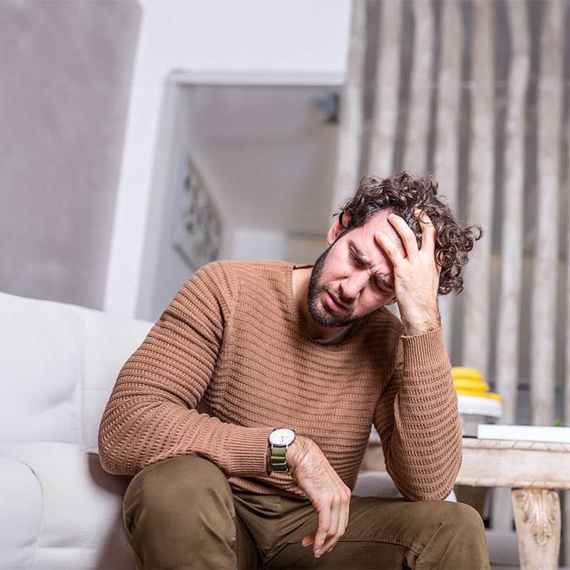 Man resting his head on his hand in distress