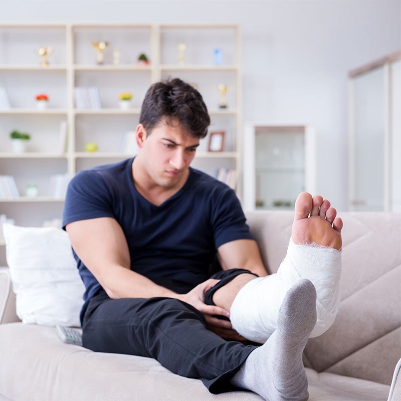 Man on couch with broken foot
