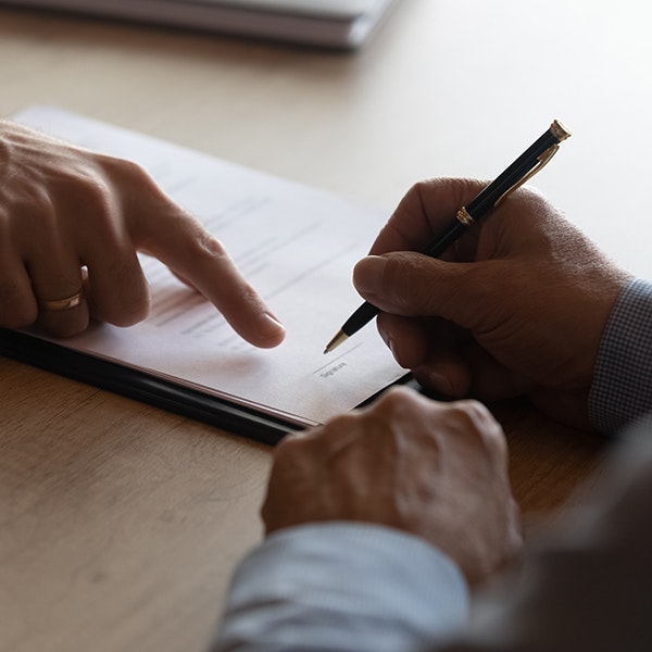 People discussing and signing paperwork