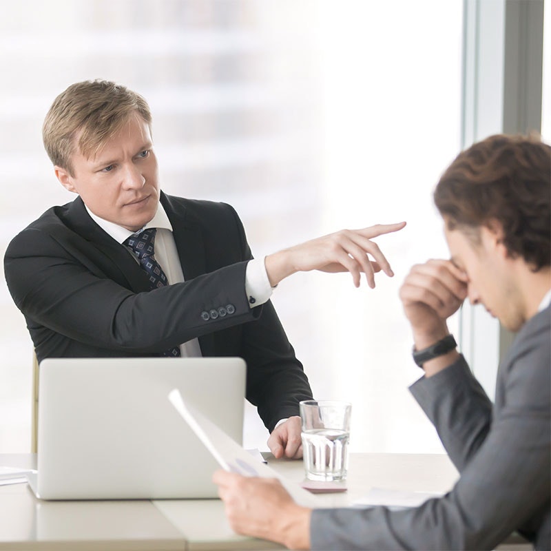 Boss yelling at employee and pointing towards the door