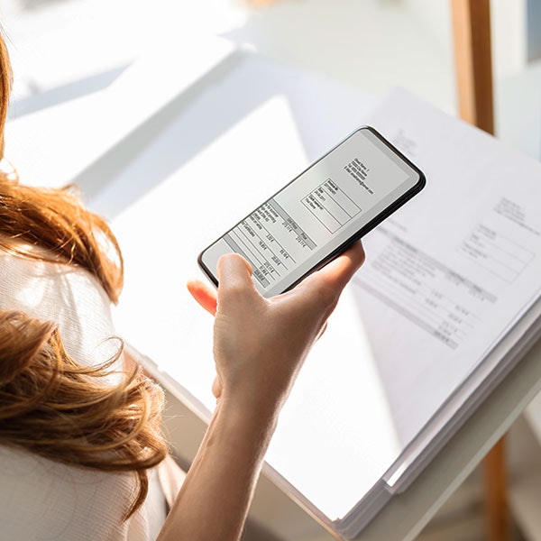 Woman sneaking photos of work documents