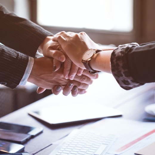 Attorney comforting a client with a handshake