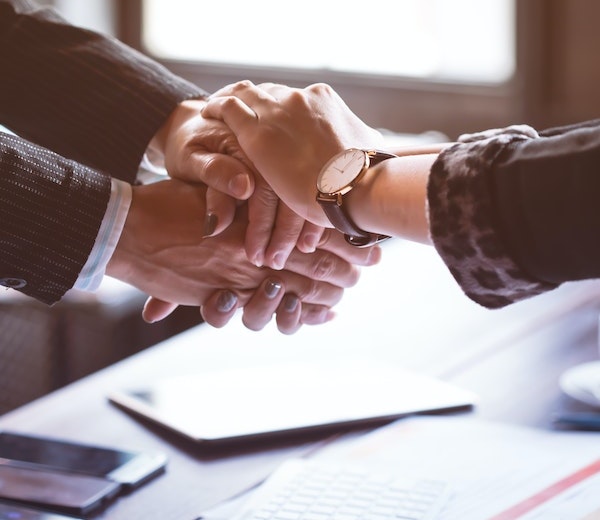 Attorney comforting a client with a handshake