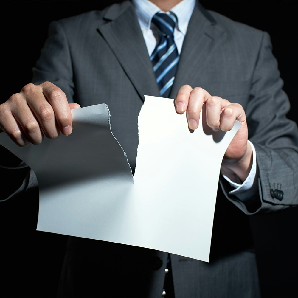 business man tearing up contract