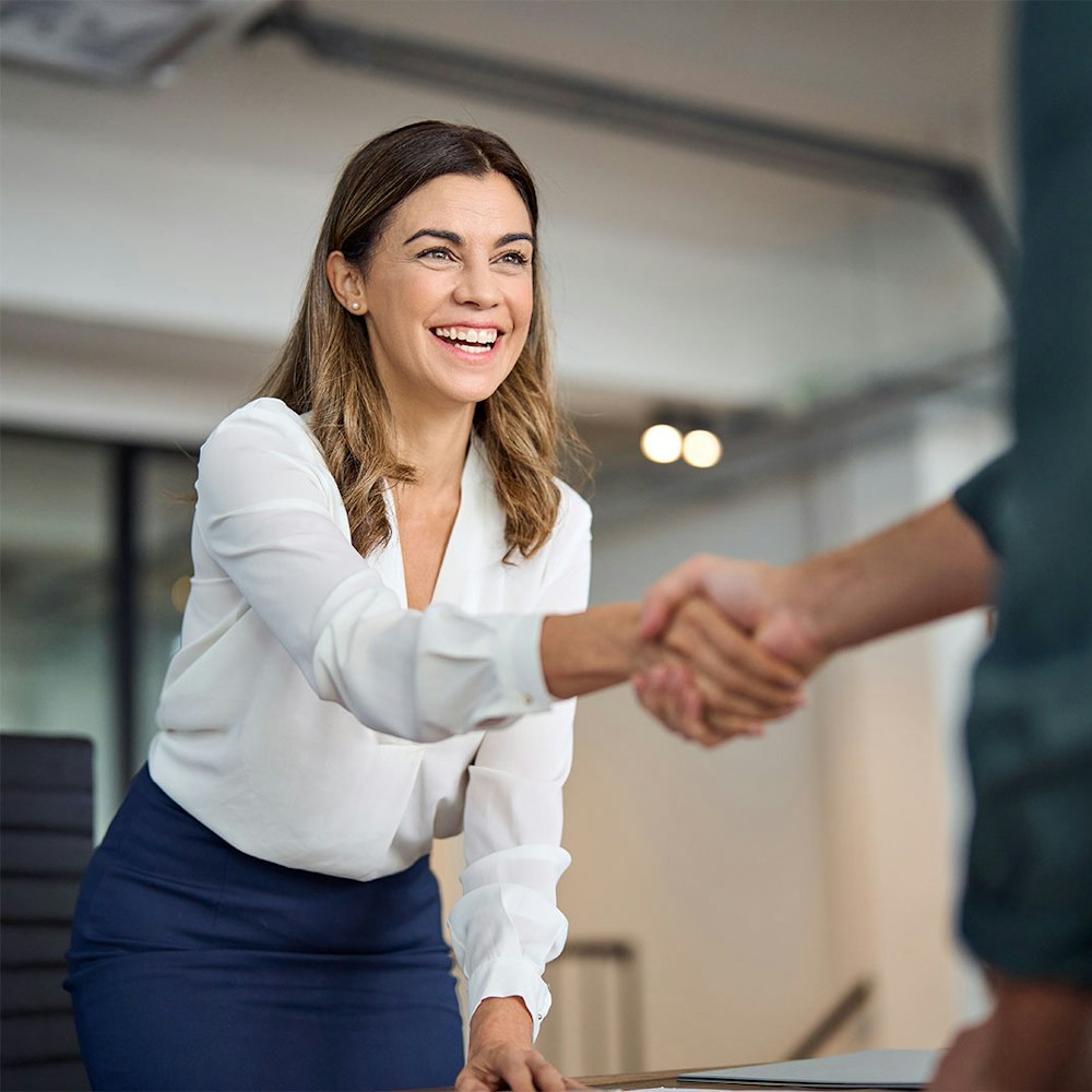 Client happily shaking lawyer's hand
