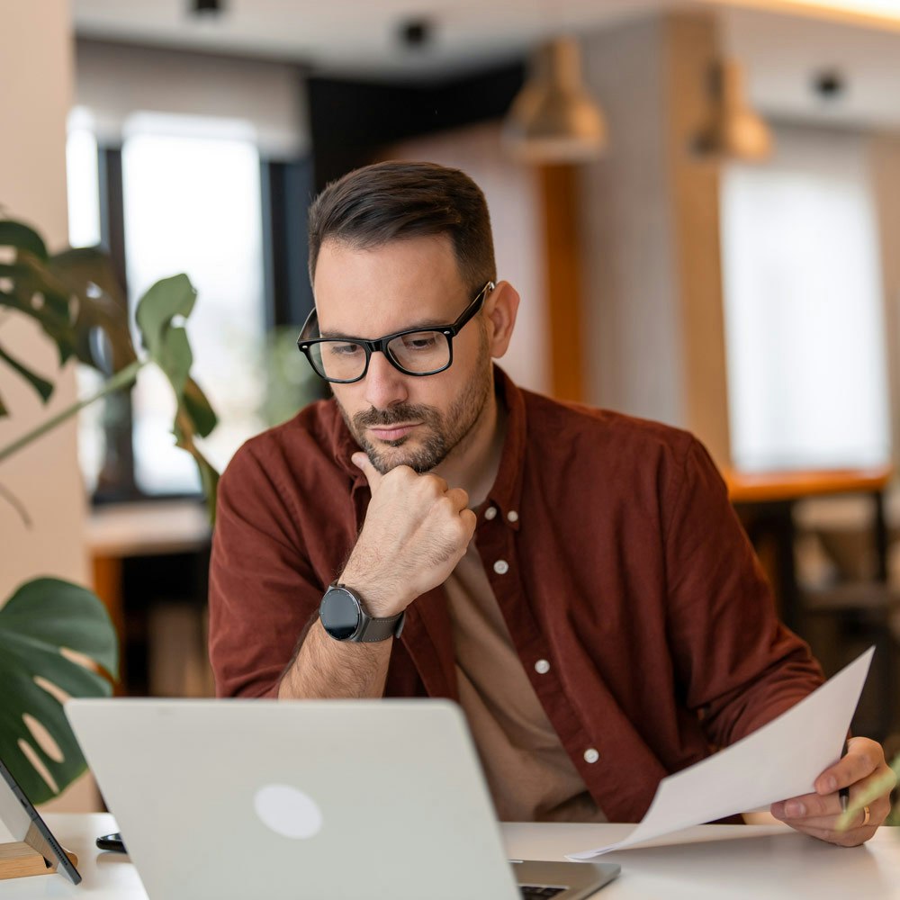 Man on laptop looking at evidence