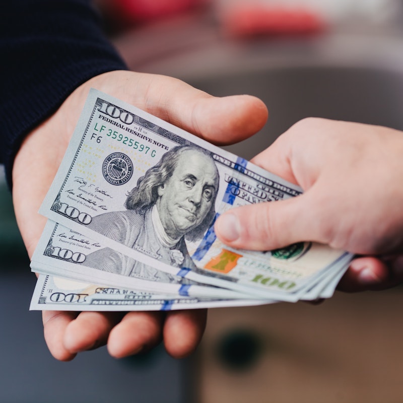 Person handing another person money
