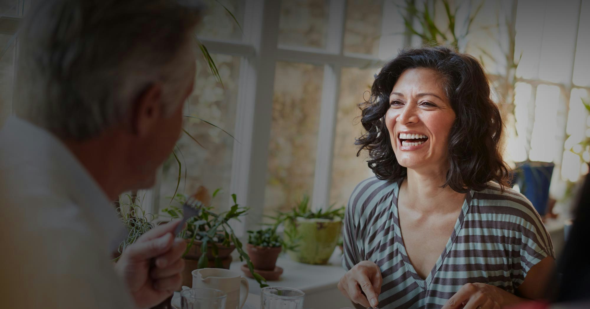 laughing woman having meal with a friend