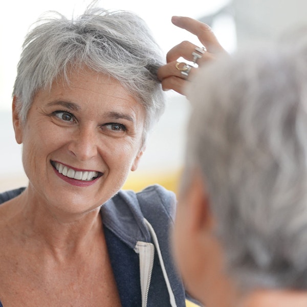 Senior woman smiling in the mirror