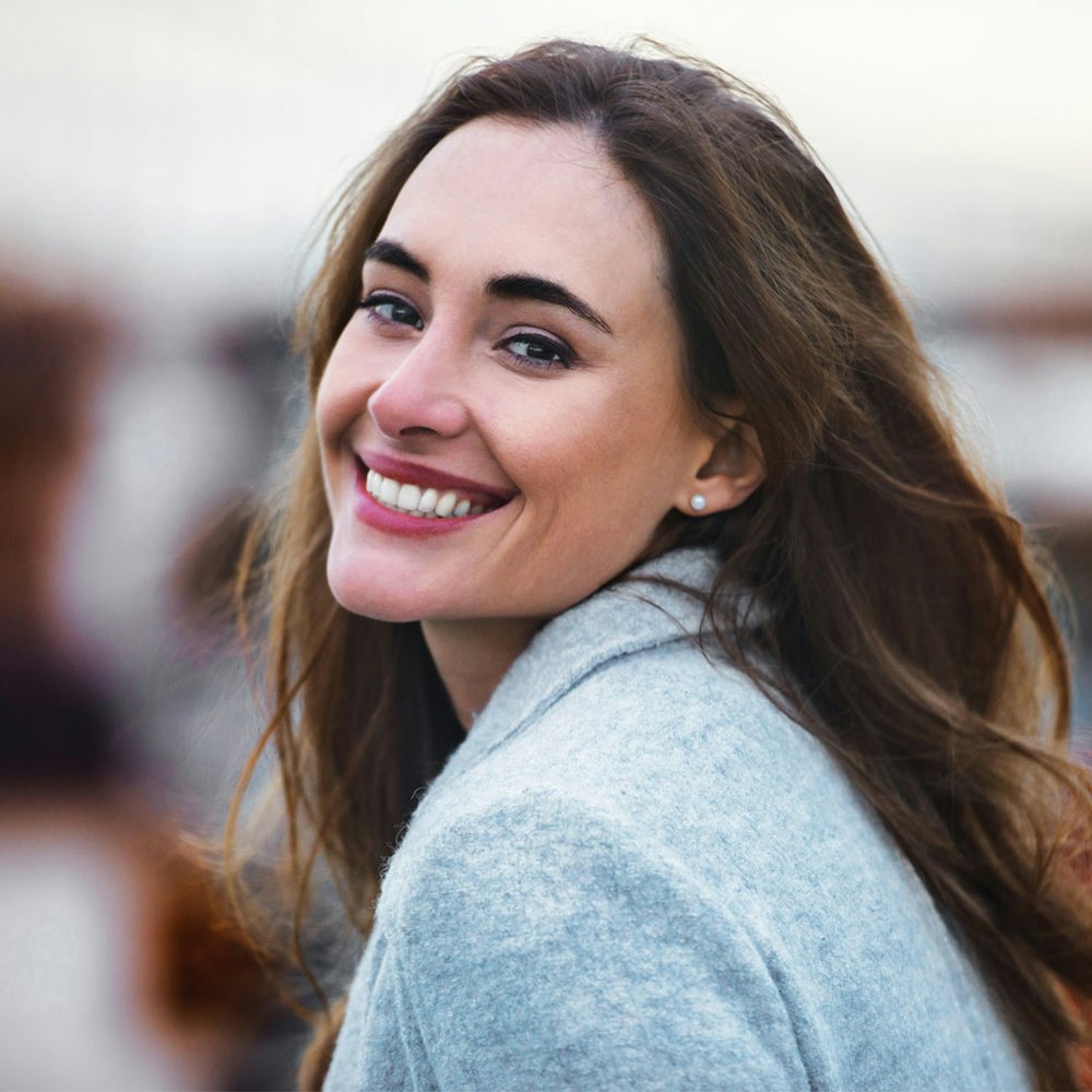 smiling woman after dental implant placement