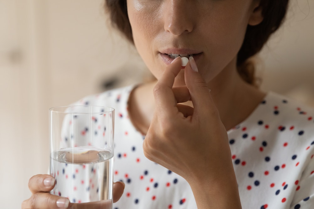 woman taking a sedation pill