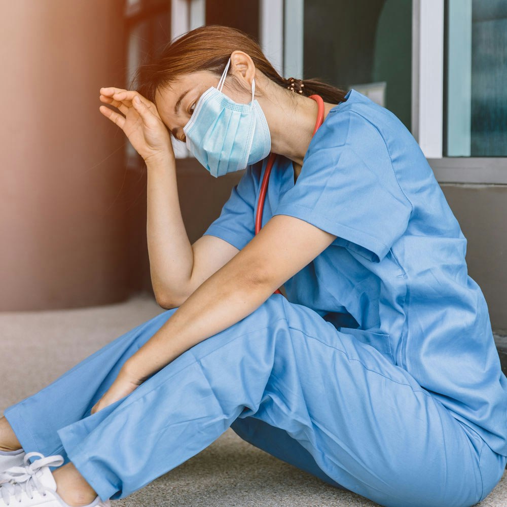 Tired medical professional sitting down