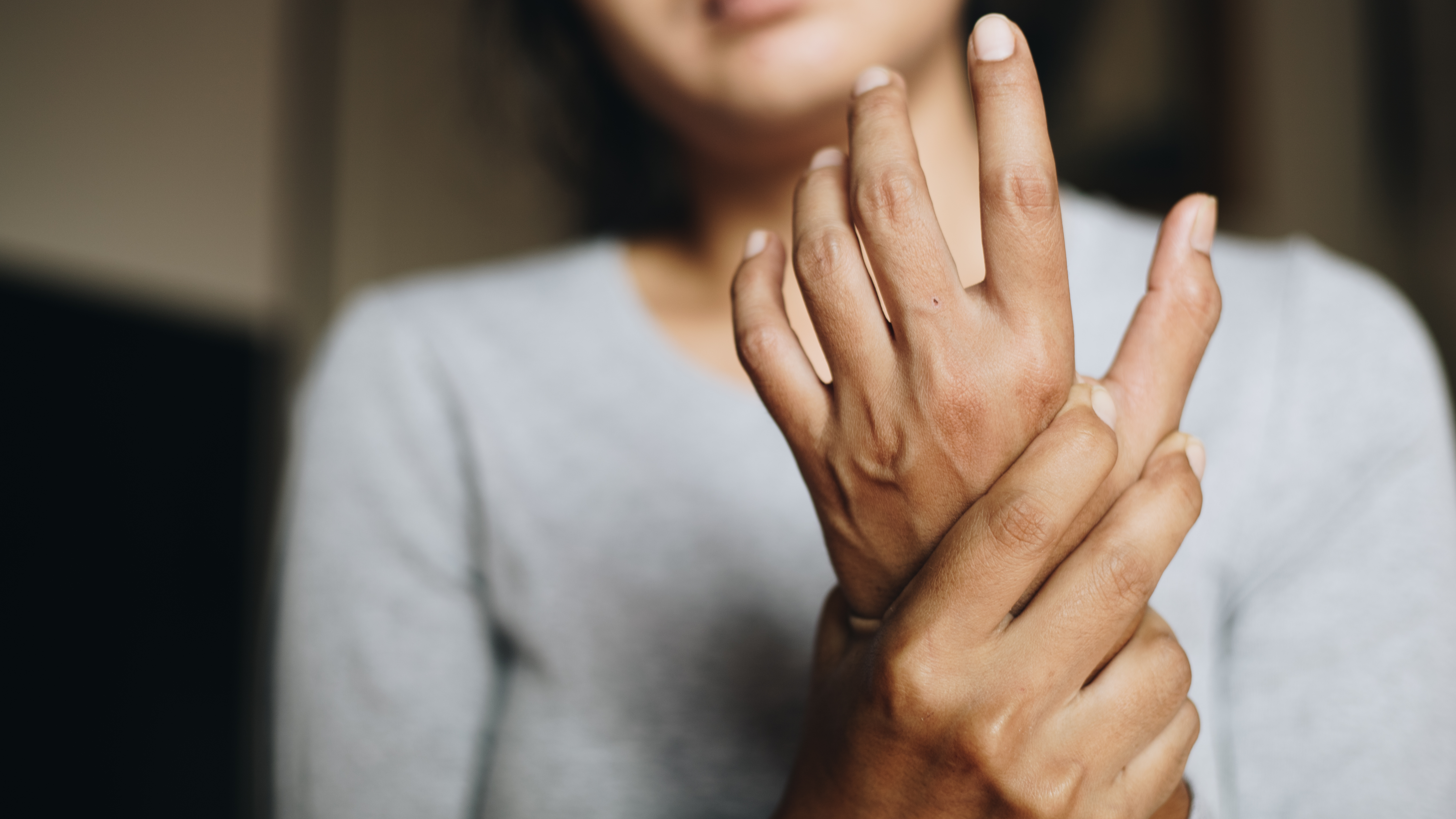 woman holding wrist because of carpal tunnel