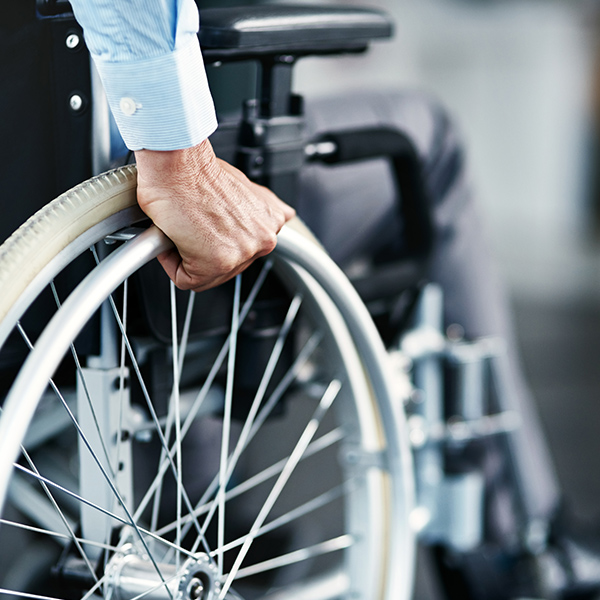 hand gripping wheelchair