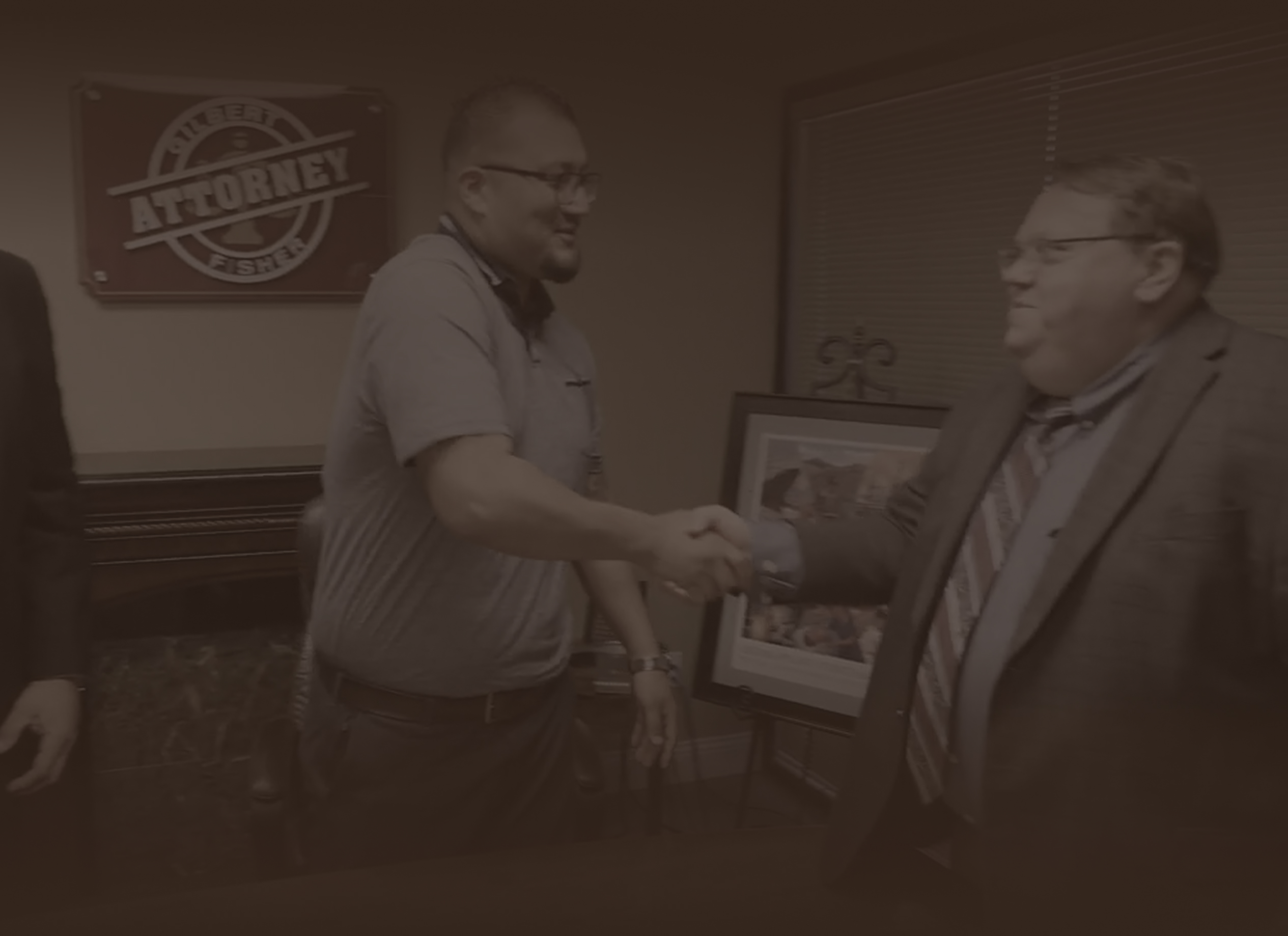 gilbert fisher shakes hands with client