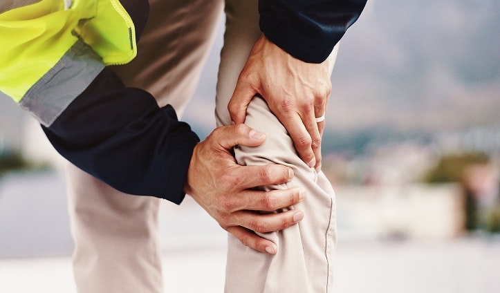 Injured worker holding his knee