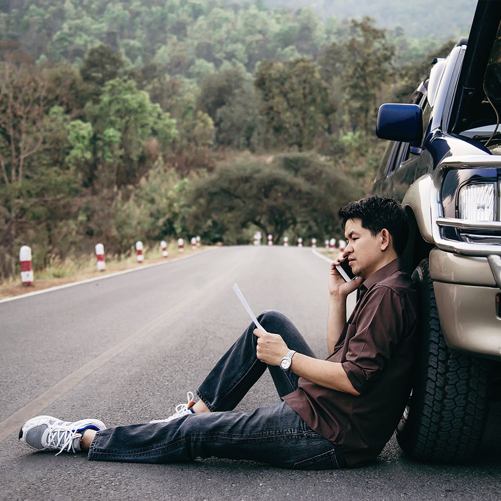 Man on phone after car accident