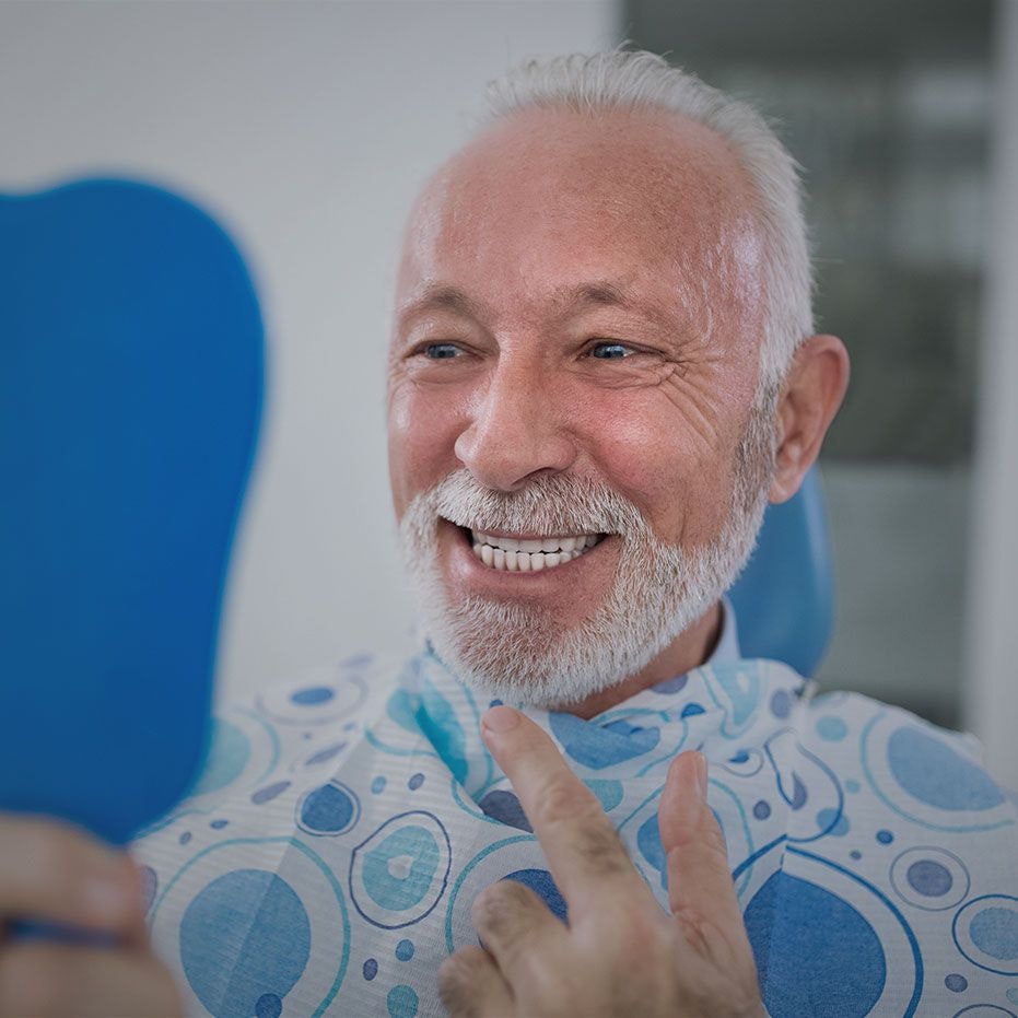 Smiling older man with hand mirror