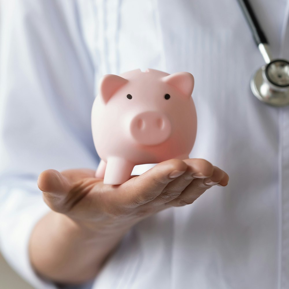 a doctor with a piggybank