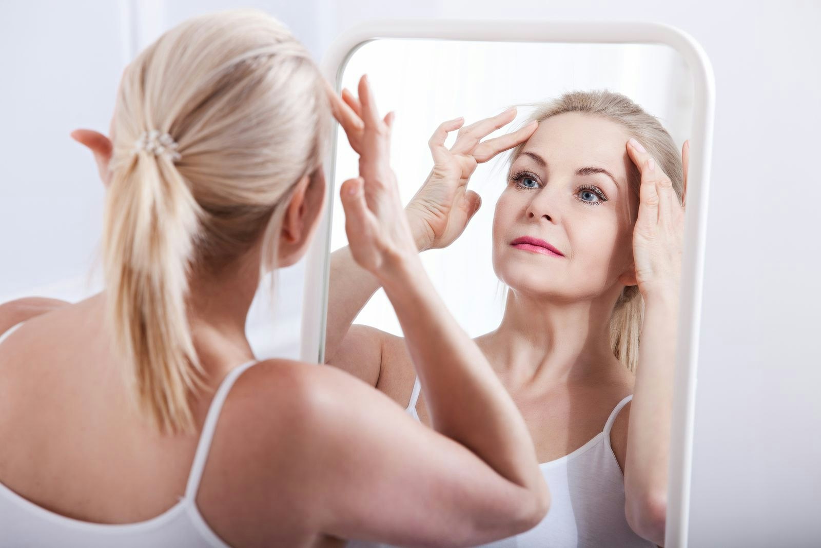 Woman primping in mirror