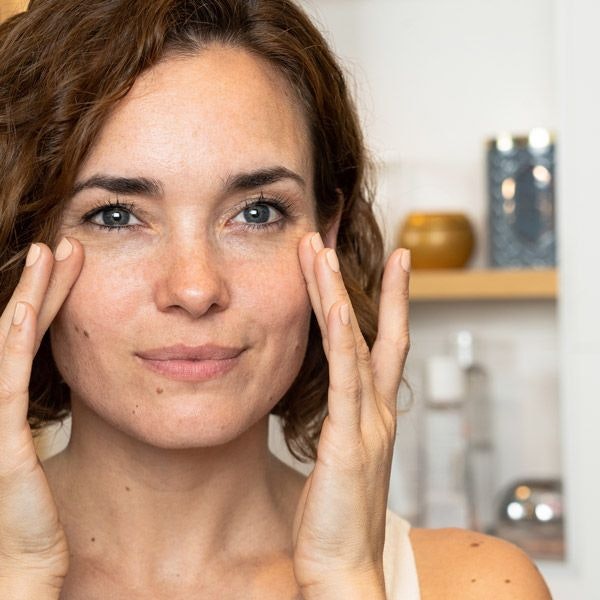 Woman touching her face