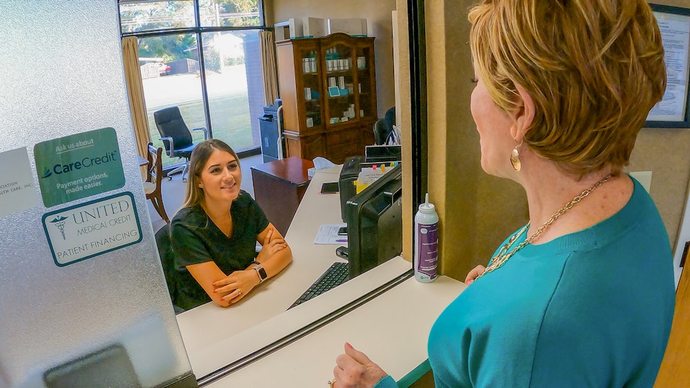 Receptionist talking to patient