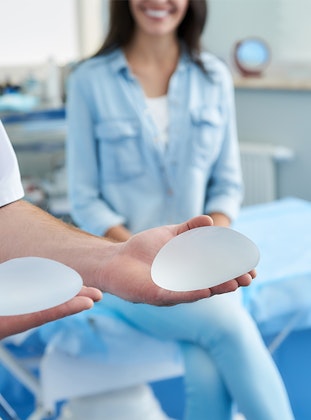 Doctor showing breast implants