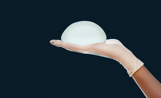 hand holding a saline implant