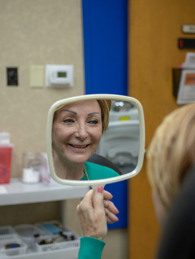 Woman smiling in a mirror