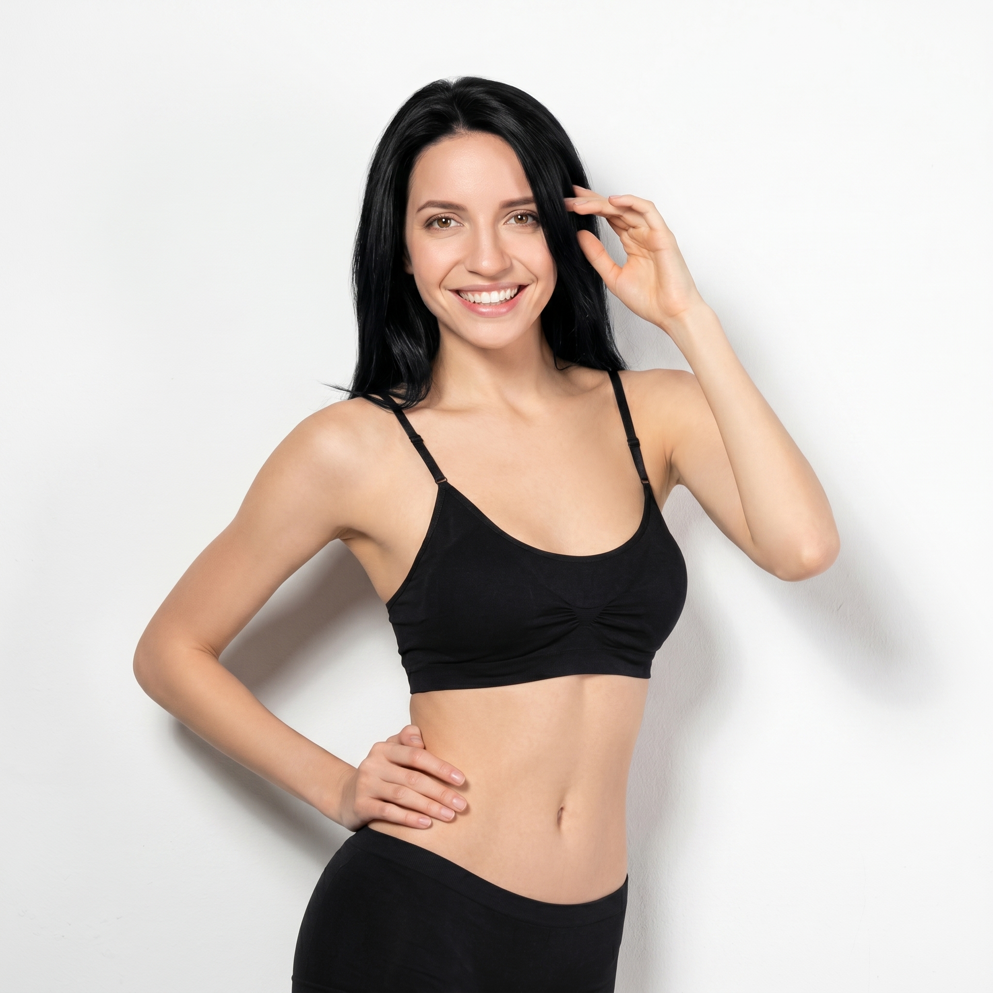 Woman with hand on her hip and hand by her forehead smiling