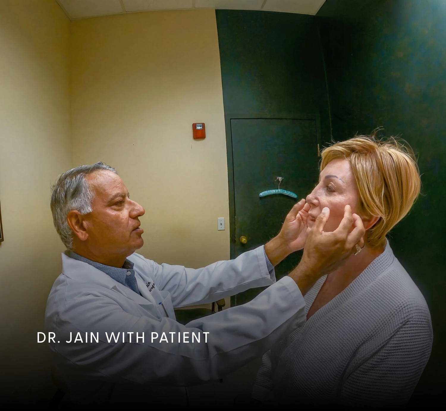 Dr. Jain examining a facelift patient