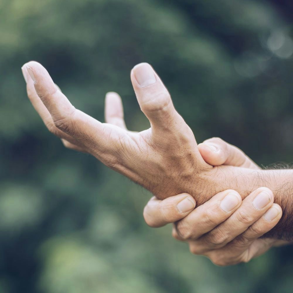 Man gripping wrist in pain because of carpal tunnel syndrome