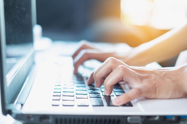 Person typing on a laptop