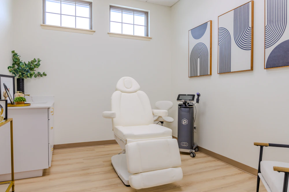 Treatment room with a white patient chair and modern decor at the Denton office