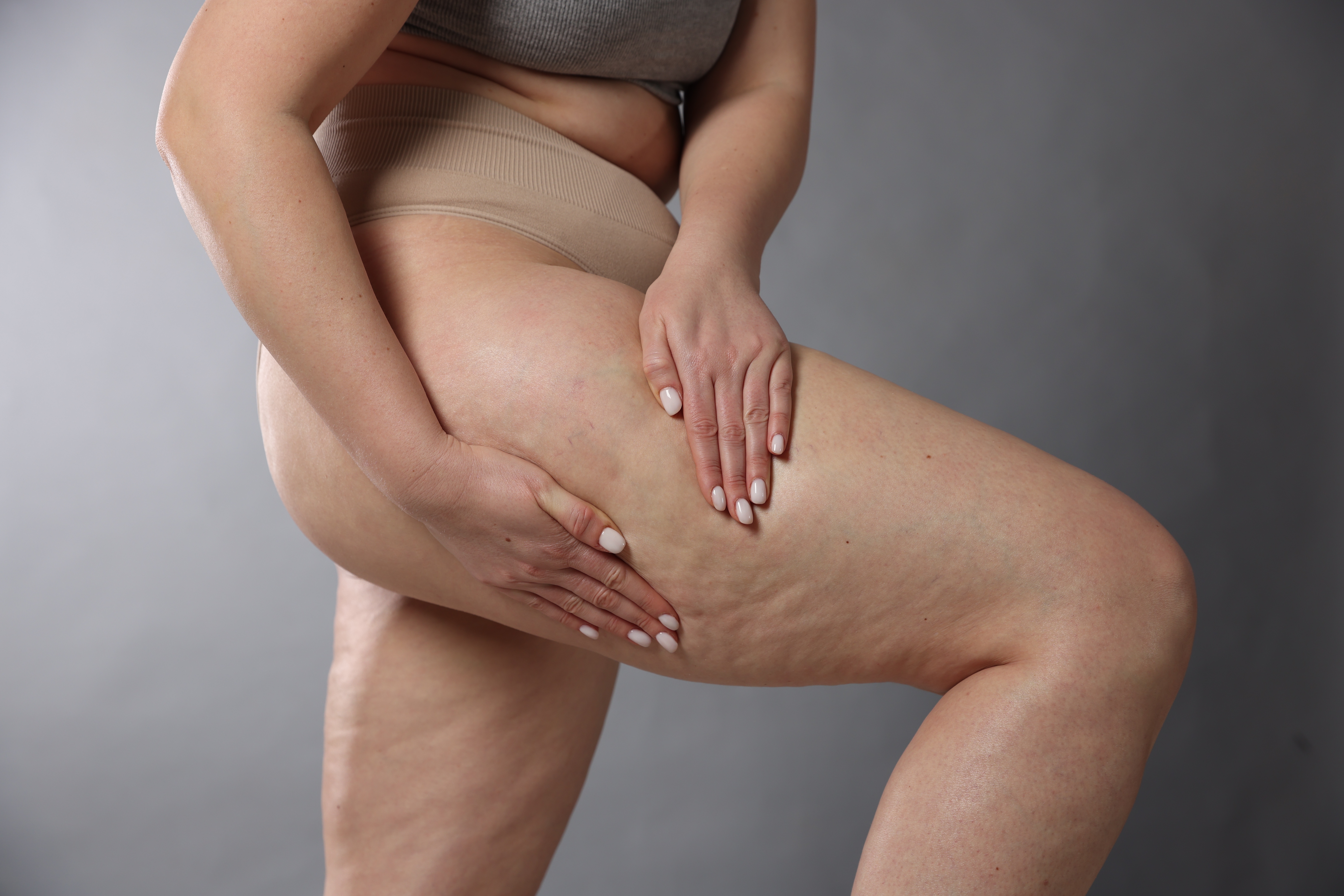 Woman pressing on upper thigh