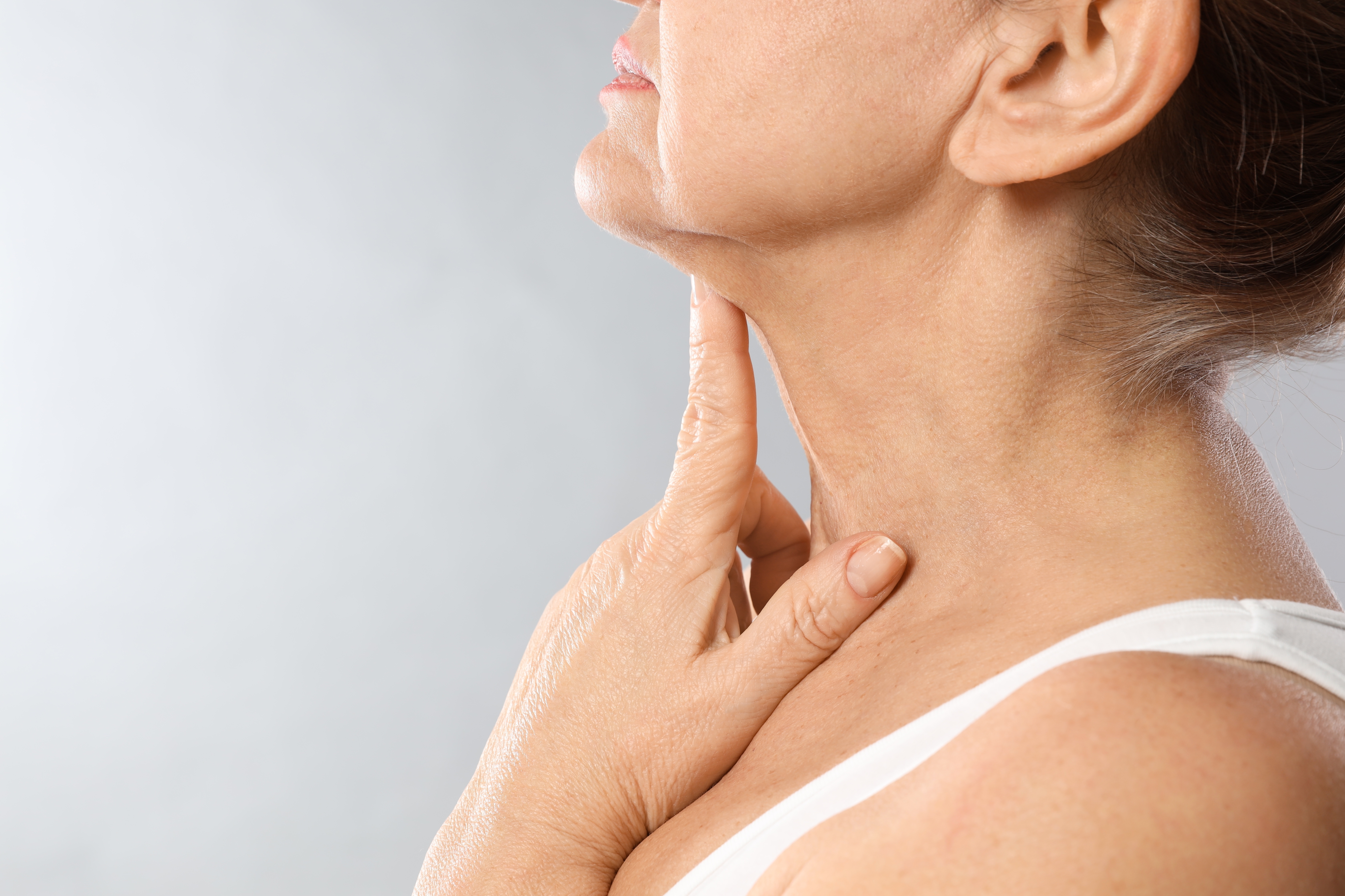 woman pointing to neck skin