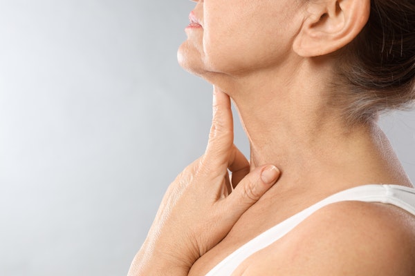 woman pointing to neck skin