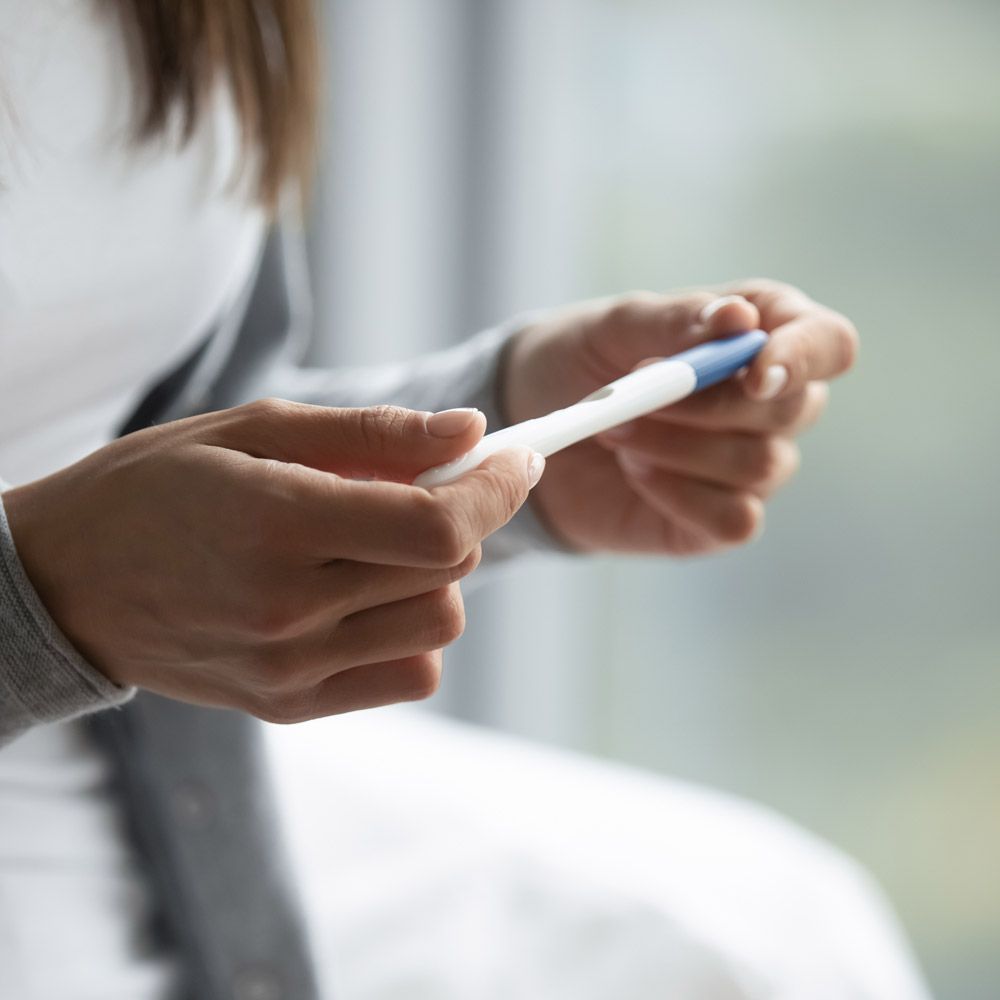 Woman holding pregnancy test