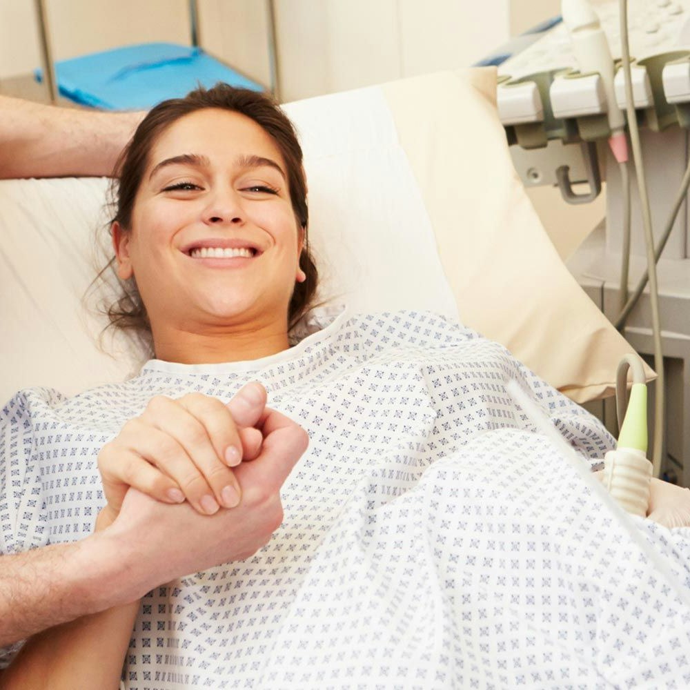Smiling woman on hospital bed
