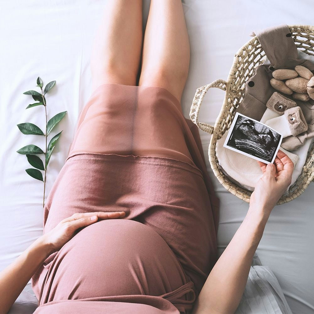 Pregnant woman holding ultrasound