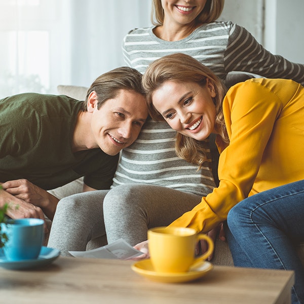 Surrogate and couple smiling